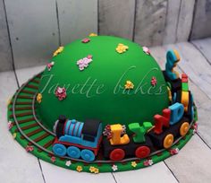 a birthday cake that is shaped like a train