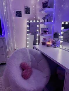 a white chair sitting in front of a mirror on top of a dresser next to a desk