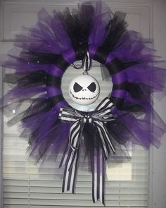 a purple and black wreath with a jack skellingy face on the front door