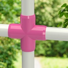 a yellow and white pole with trees in the background