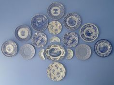 a collection of blue and white china plates