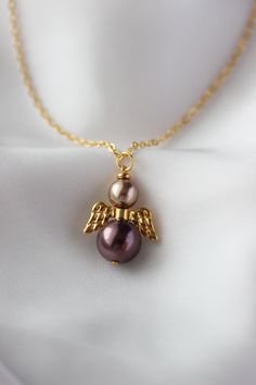 Beautiful necklace with finest quality European crystal brown-purple color, light brown pearl coated 12 and 8 mm beads, gold tone jewelry metal alloy wings separator and gold tone stainless steel chain with gold tone lobster claw. The chain is from lead & nickel free metal. Lovely memorial gift for someone special! Total length of necklace is about 63.5 cm or about 25 inches. Other necklaces of my shop you can see here: https://www.etsy.com/shop/NaTavelli?section_id=14843046&ref=shopsection_left Cute Pearl Necklace, Guardian Angel Necklace, Angel Jewelry, Angel Necklace, Necklace Pearl, Guardian Angel, Memorial Gifts, Stainless Steel Chain, Necklace Gold