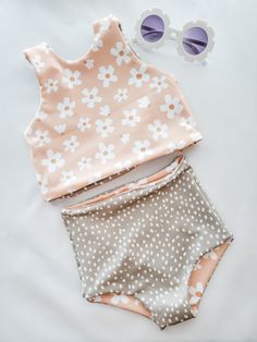 Versatile, comfortable, reversible, and oh so adorable. What more could you want in a swimsuit?!I'm so excited to introduce you to my brand new daisy floral and sage green polka dots swimsuit! The main print features super cute white daisies set against a peachy background. The coordinating polka dot fabric is a sage green with white dots.The best part of this swimsuit is that both top and bottom are fully reversible! You get multiple swimsuit looks in one!The bottoms are a trendy high waisted d Cute Spring Beach Tankini, Spring Playful Tankini For Swimming, Playful Spring Tankini, Cute Spring Tankini For Poolside, Spring Beachwear Swimwear For Play, Cute Summer Tankini For Poolside, Playful Fitted Spring Tankini, Cute Spring Tankini For Playwear, Cute Summer Tankini For Playwear