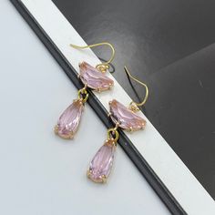 Exuding a gentle charm and subtle elegance, the Soft Pink Crystal Earrings feature luminous crystals in a tender blush hue. Their soft, rosy glow captures the essence of delicate femininity, making them a perfect accessory for those seeking a touch of romance and understated beauty in their jewelry collection. Measurements: The total length from the top of the hook to bottom - 1.77 inches (45 mm) approximately. Connector crystal: 7 mm x 15 mm Drop crystal: 16 mm x 7 mm These earrings would be a Pink Crystal Earrings, Blue Crystal Earrings, Subtle Elegance, Jewelry Bridesmaid, Clover Earrings, Sparkly Earrings, Fall Earrings, Earrings Wedding, Pink Earrings