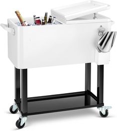 a white cooler sitting on top of a black cart filled with bottles and other items