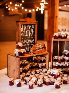 a table topped with lots of cupcakes next to a wooden box filled with cakes