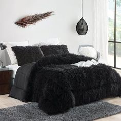 a bed with black fur on it in a room