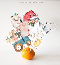 an orange vase filled with farm animals on top of a table