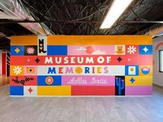 the museum of memories is brightly colored and has an interesting mural on it's wall