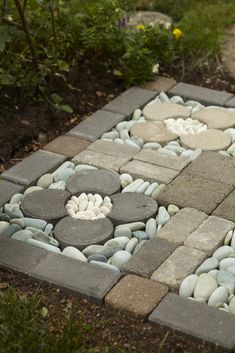 a garden with rocks and stones arranged in the shape of flowers