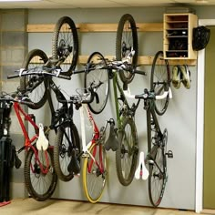 there are many bikes hanging on the wall in this bike storage area, and it's easy to use