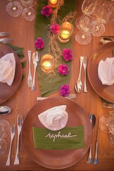 a table set with place settings and candles