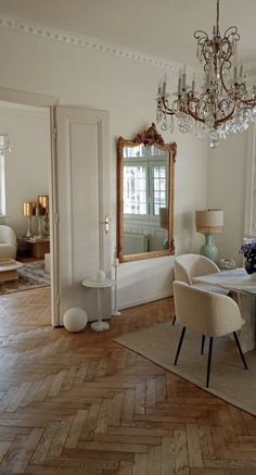 a dining room table with chairs and a chandelier