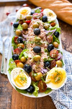 a salad with hard boiled eggs and olives