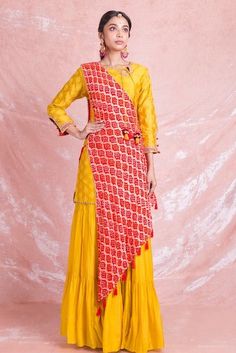 Shop stunning yellow designer sharara suit online in USA with red draped Bandhej dupatta. Champion ethnic fashion on weddings and festivals with a stunning collection of designer Indian dresses, Indowestern outfits, salwar suits, Anarkali suits from Pure Elegance Indian fashion store in USA.-full view Yellow Unstitched Floor-length Sharara, Yellow Floor-length Sharara With Sheer Dupatta, Yellow Sharara With Sheer Dupatta In Chinon, Yellow Traditional Wear With Sheer Dupatta In Chinon, Yellow Floor-length Sharara With Dori Work, Yellow Anarkali Set With Straight Kurta And Sheer Dupatta, Yellow Anarkali Style Sharara In Chinon, Yellow Chinon Palazzo Set With Traditional Drape, Yellow Chinon Palazzo Set With Dupatta