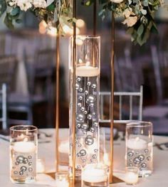 the centerpieces are filled with candles and flowers