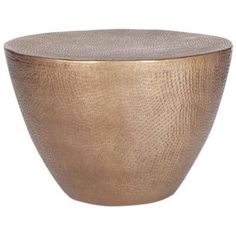 a large metal bowl sitting on top of a white surface with a gold rim and textured finish