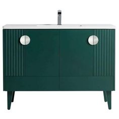 a green cabinet with two white knobs on the doors and one door is open