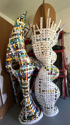 two large sculptures made out of different colored squares and lines on top of each other