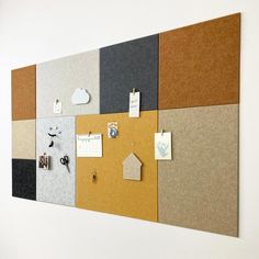 a bulletin board with several different colored papers on it and magnets attached to the wall