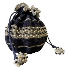 a black and white bag with beads on it