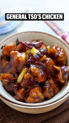 a bowl filled with meat and sauce on top of a table