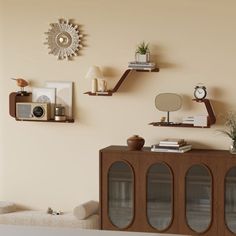 a living room filled with furniture next to a wall mounted clock and other decor items