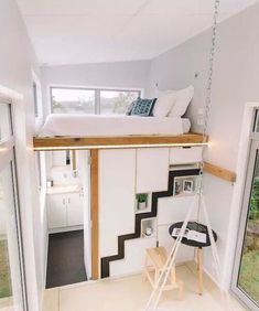 there is a loft bed in the middle of this room with stairs leading up to it