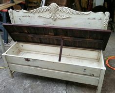 an old white bench with wooden slats on the top and bottom is being worked on