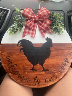 a wooden sign with a rooster on it