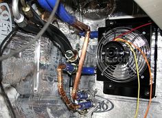 an air conditioner is shown with wires attached to the fan and hoses running through it