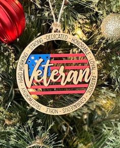 a christmas ornament hanging from the side of a tree with an american flag