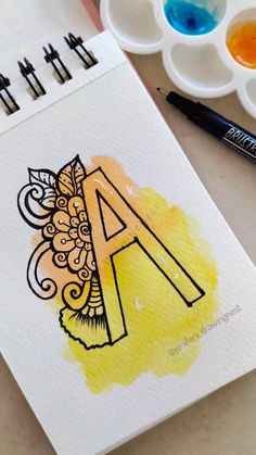 the letter a is painted with watercolors on paper