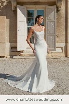 a woman in a wedding dress standing outside