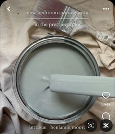 a paint can with a brush on top of it