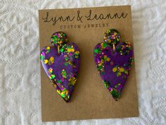 Welcome to my shop.  If you love glitter you have come to the right place. These Mardi Gras resin earrings are amazingly light weight and will make a statement with any outfit.  It's like a party on your ears.    I will normally ship in 1-2 days (not including holidays and weekends) All of my earrings are hand poured using resin, glitter, mica powders, alcohol inks.  Earrings are finished with findings containing brass and stainless steel that are hypoallergenic and nickel free. Every pair of earrings will be slightly unique and could have minor flaws since they are hand poured. Purple Glitter Earrings For Gift, Bling Gifts, Teachers Gifts, Resin Glitter, Nickel Free Jewelry, Alcohol Inks, Gifts For Teachers, Mica Powder, Resin Earrings