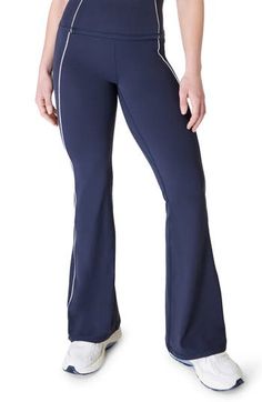 A flare-leg silhouette and scalloped piping add a sweet element to softly sculpted pants cut with plenty of stretch to move with you through your workout. 31 1/2" inseam; 23" leg opening; 10 1/2" front rise; 12 1/2" back rise (size Medium) Pull-on style 69% polyamide, 31% elastane Machine wash, dry flat Imported Blue Stretch Full-length Flares, Fitted Wide Leg Blue Activewear, Blue Fitted Wide Leg Activewear, Blue Flare Pants In Elastane, Blue Flare Pants With Elastane, Sporty Blue Wide Leg Yoga Pants, Sporty Flare Bottoms In Elastane, Fitted Flare Pants For Gym, Fitted Flare Gym Pants