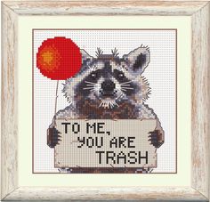 a raccoon holding a sign with the words to me you are trash on it