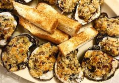 an image of a plate of food with bread and oysters on the half shell