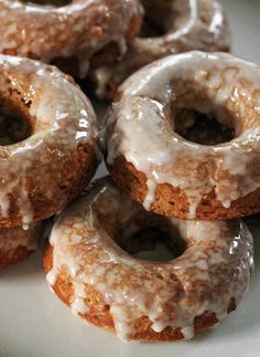 glazed donuts with icing on a white plate