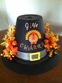 a black hat with orange flowers on it and the words give thanks written on top