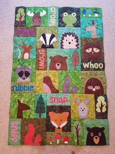 there is a quilt made to look like it has animals on it and words in the middle