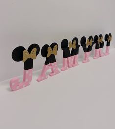 a row of wooden letters with minnie mouse heads