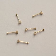 Style A tiny and cute 14K gold nose stud, without breaking the bank. You could never go wrong with such a classic design. It is a dazzling symbol of your personality. Metal It is made of 14K yellow gold. 14K gold contains 58.5% gold and 41.5% alloy. Compared to 10K, 18K, and 24K, it is the most popular choice, nearly 90% of all wedding rings and engagement rings sold in the United States consist of 14K gold. It’s durable and will not easily tarnish. Packaging It is ready as a gift! This 14K gold nose bone stud is made with love and will arrive in a jewelry box. Whether for yourself or for the one you love, it is an excellent choice. Dainty Yellow Gold Piercings With Single Diamond, Minimalist Gold Piercings With Single Diamond, Dainty Gold Piercing With Single Diamond, 14k Gold Nose Studs With Prong Setting Gift, 14k Gold Prong Setting Nose Studs For Gift, Elegant Tiny Yellow Gold Nose Studs, Dainty Yellow Gold Nose Studs For Gift, Dainty Yellow Gold Nose Studs As Gift, Minimalist 14k Yellow Gold Nose Rings