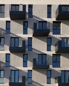 an apartment building with balconies and windows