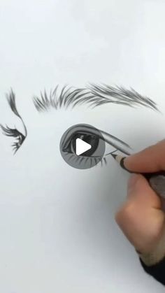 someone is drawing an eye with pencils