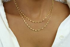 A dainty, feminine, and minimalist chain necklace. Layer it with your favorite necklace or let it shine on its own.  This beautiful chain is easy to style and is a great everyday piece. Please note: This listing is for one chain necklace only. The model pictured is layering it with some of our beautiful pieces.  18K  G O L D  F I L L E D   * All chains are 18k gold-filled. * 18k gold-filled jewelry is created with a thick layer of 18k solid gold over a metal core. * Gold-filled jewelry is a beau Elegant Everyday 14k Gold Filled Layered Necklace, Elegant Layered Necklace With Paperclip Chain, Dainty Double Chain Necklace For Gift, Elegant Layered Paperclip Chain Necklace As Gift, Elegant Paperclip Chain Layered Necklace Gift, Elegant Paperclip Chain Layered Necklace For Gift, Everyday Jewelry Gold, Minimalist Chain, Twisted Chain