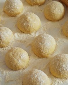 doughnuts are sitting on a baking sheet ready to be baked in the oven