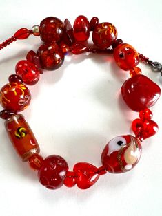 Vintage Murano red and orange glass beads are in different shape and size, there are two heart shape glass beads ,  hand-painted glass, glass with foil. The whole necklace is make of glasses strung on black wire, finished with toggle clasp. There is no two beads look the same as they are all handmade. Very romantic handmade vintage jewellery, gift for her. In great vintage condition with  small wear. Especially on the clasp. Send from France. Everything I share here is vintage, it means they are old and original and can have signs of age. That's the beauty of it ( in my eyes). But I will let you know any notable features or damage. Feel free to contact me with any questions :) Thank you for visiting and enjoy your shopping!  Chez Echo Vintage  https://chezechovintage.etsy.com Glass Heart Beads Necklaces, Glass Heart Bead Necklace, Glass Heart Beads Necklace, Adjustable Murano Glass Necklaces With Round Beads, Adjustable Murano Glass Necklace With Round Beads, Adjustable Murano Glass Round Beads Necklace, Adjustable Murano Glass Beaded Necklaces With Round Beads, Adjustable Murano Glass Beaded Necklaces, Hand-painted Red Jewelry For Valentine's Day