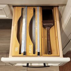 an open drawer with knives and spatulas in it